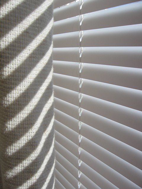 Morning light on blinds and curtains